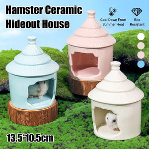 Ceramic hamster house hideout in pink, blue, and white, designed for cooling and comfort.